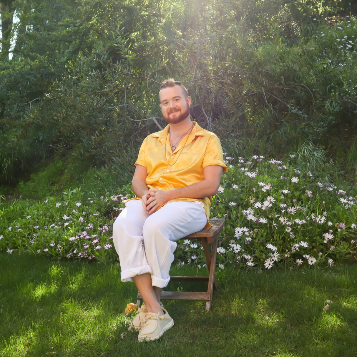 James Beaulieu sitting in a sunlit garden